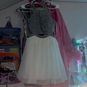 short gray and white dress with an cut out in the stomach area